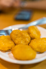 Pile of golden deep fried battered chicken nuggets, fast food