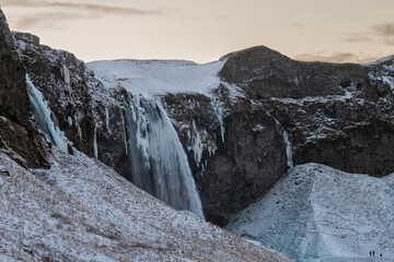 Seljalandsfoss Waterfall in winter, on the south coast of Iceland. Beautiful arctic landscape.
