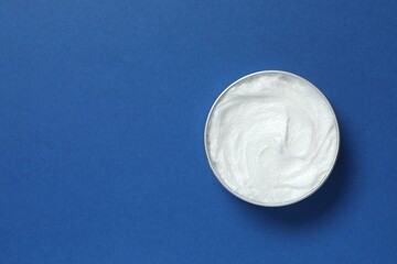 Jar of body cream on a color background
