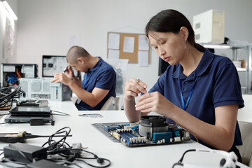 Technicians Assembling Computer Components in Laboratory