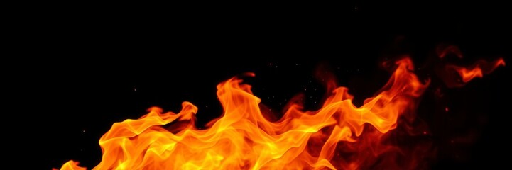 Fototapeta premium Intense fiery flames dancing on a dark black background, spark, energy, power