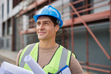 Pensive engineer looking away with hope