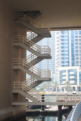 Spiral staircase on a building in the city center near a water channel. Staircase outside the building.