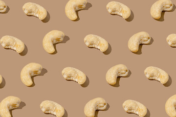Creative pattern made with cashew nuts on beige background. Healthy food ingredient concept .Minimal style. flat lay. Top view