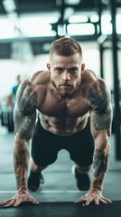 A muscular man performs push-ups in a gym, showcasing strength and fitness dedication.