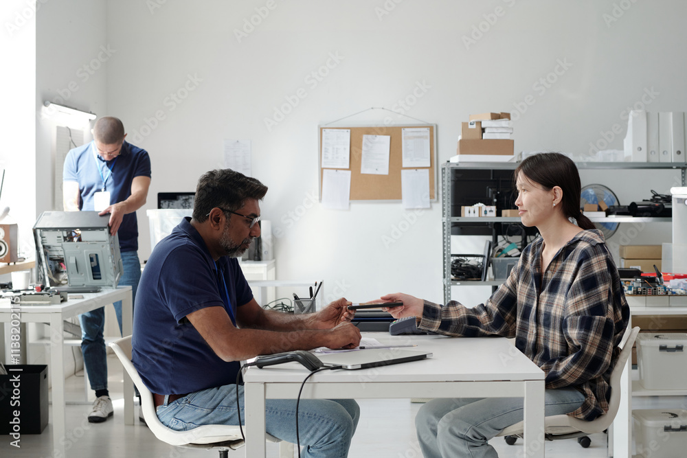 Aufkleber collaborating in modern office setting with tech gadgets