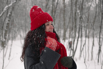 Fototapeta premium Snowy day joy: red hat, scarf, and gloves