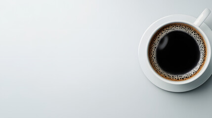 A simple cup of black coffee sits on a light background, emphasizing its rich color and inviting aroma