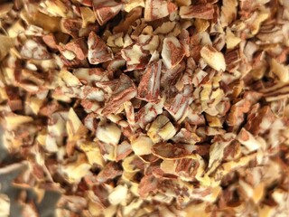 Supari a popular form of betel nut in India, where small pieces are sold in packets or pouches, often mixed with tobacco and other ingredients. Close up of small ingredients of supari 