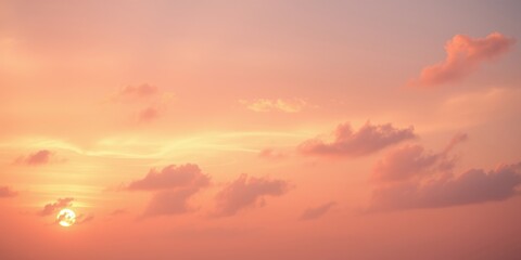 Fototapeta premium A soft, peach-hued sky with the sun shining through wispy clouds, creating a serene and tranquil atmosphere