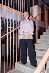 Vertical full length shot of mature businesswoman wearing pink shirt outfit confidently posing for...
