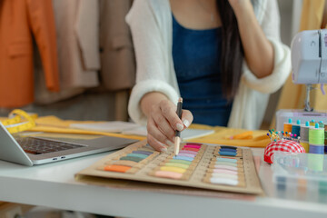 beautiful young lady tailor at work, beautiful female designer at design studio, crop view of fashion designer at work, woman in tailor workshop, clothing designer in workshop.