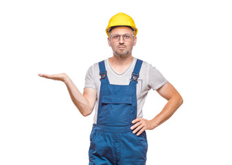 Construction worker holding free advertising space for your product on his palm, isolated on white background. Happy promoter repairman, copy space for text. Craftsman against white wall