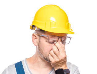 Drowsy middle-aged construction worker looking at camera, isolated on white background. Close-up exhausted repairman. Sleepy expression. Craftsman against white wall