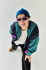 A stylish young man sports a bomber jacket and sunglasses, reflecting youth culture.