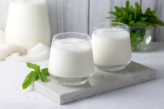 Glass cup of Turkish traditional drink ayran , kefir or buttermilk made from yogurt, healthy food