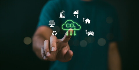 Businessman point to increasing arrow with carbon reduction for decrease CO2, Green house Global Economy concept. Carbon footprint and carbon credit to limit global warming from climate change.