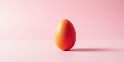 A single, orange egg resting on a soft pink surface, casting a subtle shadow, symbolizing new beginnings and potential
