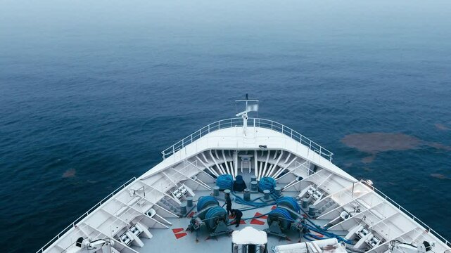 4K video of the bow of a ship moving through foggy water, POV shot.