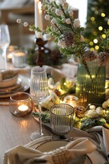 Christmas place setting with festive decor on wooden table in room