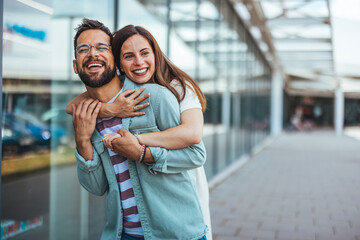 Happy Couple Embracing Outdoors in a Stylish Urban Setting