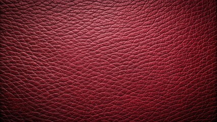 Fototapeta premium Rich burgundy leather texture background with a luxurious, smooth surface. The deep red tone adds elegance and sophistication to various design projects.