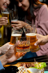 food and drink male friends are happy drinking beer and clinking glasses at a bar or pub.