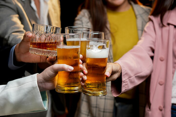  
food and drink male friends are happy drinking beer and clinking glasses at a bar or pub.