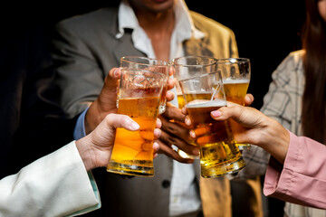 food and drink male friends are happy drinking beer and clinking glasses at a bar or pub.