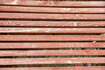 Weathered Wooden Fence with Natural Grain Texture and Rustic Red Paint