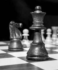Chessmen photographed on a chessboard with a dark background