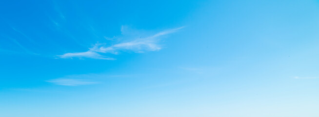 Small white clouds in the blue sky