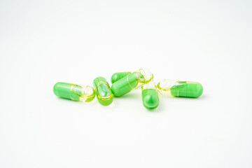transparent pills with a mixture of green powder and oil, Food supplements, vitamins and minerals