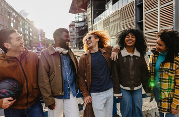 Happy multi ethnic friends laughing together in the city