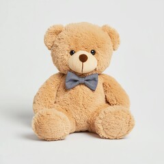 Obraz premium A cute, plush teddy bear with a bow tie, sitting upright against a plain background, perfect for gifting or decoration.
