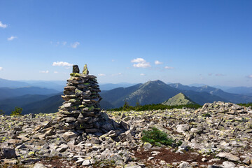 Stack of zen stones, natural rocks stacked on top of each other in the mountains in summer. Concept of harmony and balance. Tonal perspective