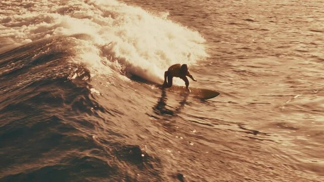 Surfer aerial. Surfer rides the wave in the Maldives. Aerial view of the rider on a wave