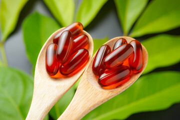 wooden spoon with soft gels, Fish oil capsules, omega 3, omega 9, vitamin D, vitamin E