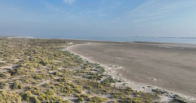 Aerial footage of the Dunes of Texel National Park on a sunny day in De Koog, Texel, Netherlands