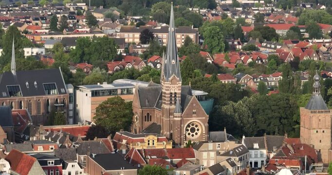 Aerial footage of the Heilige Barbarakerk Catholic church on a sunny day in Culemborg, Netherlands
