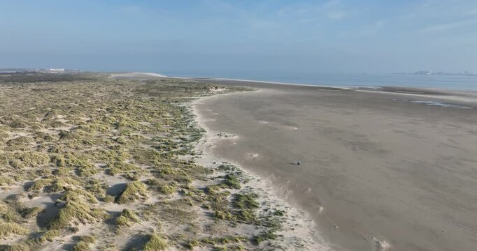 Aerial footage of the Dunes of Texel National Park in De Koog, Texel, Netherlands, on a sunny day