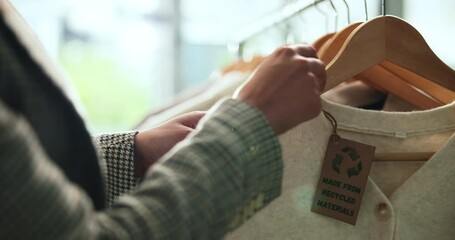 Shopping, eco friendly choice and hands of woman with clothes in store for bargain retail sale. Mall, sustainable fashion and customer in boutique for products, recycled fabric or clothing price tag