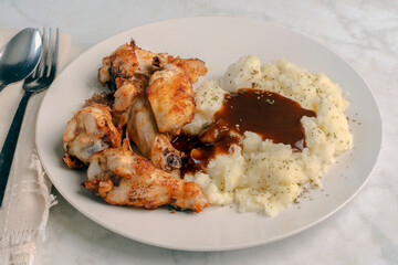chicken  wings and drumsticks  with mashed potatoes