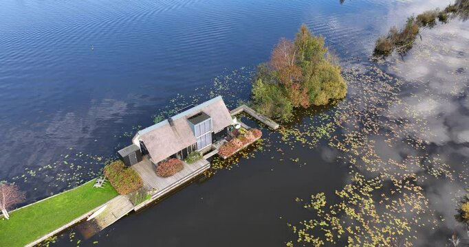 Drone footage of a small house on Loosdrechtse plassen lake, near Scheendijk hamlet, Netherlands