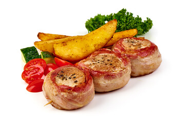 Bacon-wrapped pork medallions with potato wedges, isolated on white background.