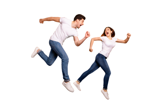 Full length side profile body size photo funky she her he him his pair jumping high hurry shopping raised fists yell scream shout loud wear casual jeans denim white t-shirts isolated yellow background
