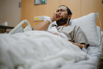 A male influenza patient is stressed about his symptoms.