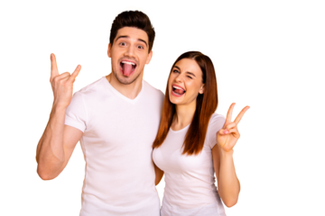 Close up photo beautiful amazing she her he him his guy lady pair hold hands arms  v-sign metal concert horns tongue out mouth wink eye carefree wear casual white t-shirts isolated yellow background