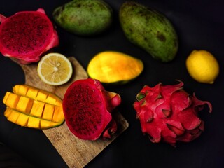 Selective focus of fresh fruit on black background