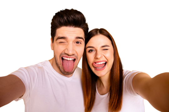 Self-portrait of his he her she two nice attractive cheerful cheery childish comic playful people husband wife showing tongue out having fun isolated over vivid shine bright yellow background